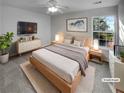 Comfortable bedroom featuring a ceiling fan, a large window, and neutral decor at 2985 Whittier Way, Cumming, GA 30040