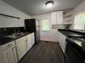 Functional kitchen with stainless steel refrigerator, black countertops, and white cabinetry offering ample storage space at 3155 Oakcliff Nw Rd, Atlanta, GA 30311