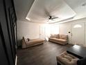 Bright living room with neutral decor, tray ceiling, ceiling fan and hardwood floors, creating a cozy and inviting atmosphere at 3155 Oakcliff Nw Rd, Atlanta, GA 30311