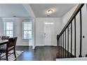 Bright entryway featuring hardwood floors, a staircase, and a freshly painted white front door at 4825 Odum View Ln, Cumming, GA 30040