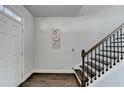 Bright entryway featuring hardwood floors, a staircase, and a freshly painted white front door at 4825 Odum View Ln, Cumming, GA 30040