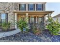 Cozy front porch with detailed columns and landscaping offering a welcoming entrance to the home at 4825 Odum View Ln, Cumming, GA 30040