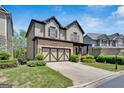 Charming two-story home featuring stone accents, a two-car garage, and a beautifully landscaped front yard at 5928 Cobblestone Creek Cir, Mableton, GA 30126