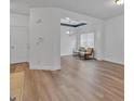 Bright, open-concept living room with hardwood floors, large windows, and neutral paint colors at 5928 Cobblestone Creek Cir, Mableton, GA 30126