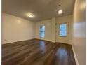Open-concept living room with hardwood floors, neutral walls, and plenty of natural light at 5928 Cobblestone Creek Cir, Mableton, GA 30126