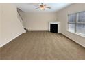 Spacious carpeted living room with fireplace, lots of light, and staircase at 1181 Paramount Dr, Mcdonough, GA 30253