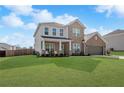 Charming two-story brick home featuring a manicured lawn and an attached two-car garage at 236 Himalaya Way Way, Mcdonough, GA 30253