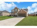 Charming two-story brick home featuring a manicured lawn and a long concrete driveway at 236 Himalaya Way Way, Mcdonough, GA 30253