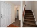 Inviting entryway featuring neutral walls and carpeted stairs, illuminated by recessed lighting at 239 Valley Xing, Canton, GA 30114