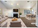 Staged living room with fireplace, plush rug, dining table, and plenty of natural light at 2721 Arctic Ct, Morrow, GA 30260