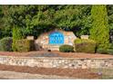 Stone entrance sign for Silver Ridge community, surrounded by lush greenery and manicured landscaping at 847 Sand Ln, Lawrenceville, GA 30045