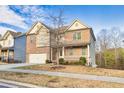 Charming two-story brick house with attached garage, complemented by a manicured lawn and inviting front porch at 847 Sand Ln, Lawrenceville, GA 30045