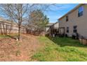 A spacious, grassy backyard with a wooden fence, patio, and well-kept lawn; perfect for outdoor entertaining at 1077 Roanoke Ave, Mcdonough, GA 30253