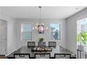 Elegantly decorated dining room with dark wood table, chandelier lighting, and natural light, perfect for Gathering gatherings at 1077 Roanoke Ave, Mcdonough, GA 30253