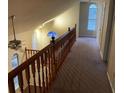 Upstairs hallway with beautiful railing and carpeted floor at 2068 Bedford Ct, Lithonia, GA 30058