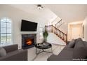 Inviting living room with a fireplace, large windows, and a staircase leading to the upper level at 2068 Bedford Ct, Lithonia, GA 30058
