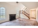 Inviting living room with a fireplace, large windows, and a staircase leading to the upper level at 2068 Bedford Ct, Lithonia, GA 30058
