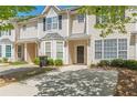 Inviting two-story townhome with a private entrance, landscaped front yard, and convenient parking at 2454 Brianna Dr, Hampton, GA 30228
