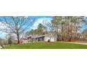 Well-maintained split-level home featuring an attached two-car garage and a lush green lawn at 3060 Eastland Way, Snellville, GA 30078