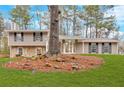 Attractive split-level residence with stone veneer, balanced facade, and a verdant front lawn at 3060 Eastland Way, Snellville, GA 30078