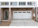 View of the private garage with brick surround and a side entrance door at 403 Inglenook Walk, Marietta, GA 30060