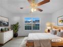 Cozy bedroom featuring a large window, ceiling fan, and comfortable modern decor at 5158 Summersun Dr, Morrow, GA 30260