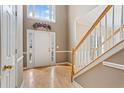 Two-story foyer featuring a decorative plant arrangement above the entrance and a staircase to the side at 1390 Bridle Path Dr, Lawrenceville, GA 30045