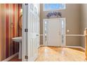 Hardwood floored entry foyer with a sink off to the side, a decorative plant and a staircase nearby at 1390 Bridle Path Dr, Lawrenceville, GA 30045