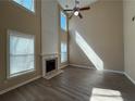 Bright living room with a fireplace and tall windows at 2728 Sandalwood Cir, Locust Grove, GA 30248