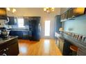 Kitchen with black cabinets, countertops and stainless appliances at 679 Victorian Cir, Dallas, GA 30157
