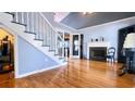 Bright living room with hardwood floors, fireplace, and staircase to the second level at 679 Victorian Cir, Dallas, GA 30157