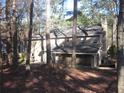 Back view of a two-story home featuring a screened porch and a partial basement at 9165 Eves Cir, Roswell, GA 30076