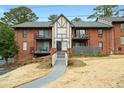 Charming brick apartment building with balconies, mature trees, and walkway at 6851 Roswell Rd # N10, Sandy Springs, GA 30328
