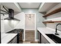 Bright kitchen showcasing stainless steel appliances, white subway tile, and gray cabinets at 6851 Roswell Rd # N10, Sandy Springs, GA 30328
