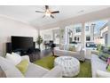 Inviting living room featuring hardwood floors, neutral paint, large windows, and comfortable seating at 710 Hudson Way, Roswell, GA 30076