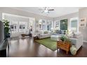 Bright living room showcasing hardwood floors, neutral paint, large windows, and comfortable seating at 710 Hudson Way, Roswell, GA 30076