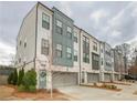 A row of modern townhomes features stylish architecture, private garages, and well-maintained landscaping at 2655 Sarah Carlin Ct, Norcross, GA 30071