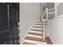 Welcoming foyer showcasing a staircase with wood treads, white risers, decorative railing, and adjacent front door at 2782 Loftview Sq, Atlanta, GA 30339