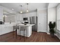 Bright kitchen featuring white cabinets, stainless steel appliances, and an island with bar seating at 2782 Loftview Sq, Atlanta, GA 30339