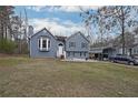 Charming two-story home with a bay window, a covered carport, and a well-manicured front yard at 41 Silverthorne Ct, Douglasville, GA 30134