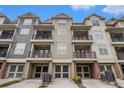 Townhome garages and rear balconies offer outdoor living in a vibrant neighborhood, showcasing curb appeal at 849 Perennial Dr, Atlanta, GA 30328