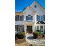 Charming front entrance with double doors, decorative wreaths, and a covered porch at 3966 Creekview Ridge Dr, Buford, GA 30518