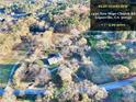 Expansive aerial view of the property showcasing its 5.99 acres of land and natural surroundings at 1430 New Hope Church Rd, Loganville, GA 30052