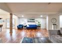 Open-concept living room featuring hardwood floors, comfortable seating, and bright, natural lighting at 1430 New Hope Church Rd, Loganville, GA 30052