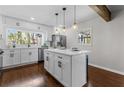 Bright kitchen with white cabinetry, quartz countertops, a center island, stainless steel appliances, and dark hardwood floors at 1521 Bentcreek Dr, Marietta, GA 30062