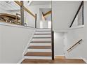 Modern staircase with wooden steps and metal railings leading to a bright, open space on the second floor at 1521 Bentcreek Dr, Marietta, GA 30062