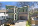 Modern two-story home with green siding, brick accents, and a two-car garage at 916 Ira Sw St, Atlanta, GA 30310