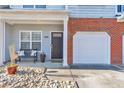 Inviting front porch with seating, plants, stone accents, and direct garage access at 2415 Clock Face Ct, Lawrenceville, GA 30043