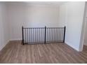 Open loft area with modern black iron railing and beautiful light-colored wood flooring at 2475 Freydale Se Rd, Marietta, GA 30067