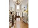 Grand foyer with high ceilings, hardwood floors, and a staircase with decorative iron railings at 3180 Wills Mill Rd, Cumming, GA 30041